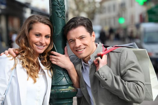 Couple holding shopping bags in town