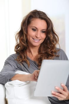 Beautiful woman connected on internet with electronic tablet