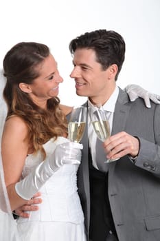 Bride and groom drinking champagne