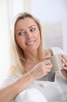 Portrait of blond woman with cup of tea