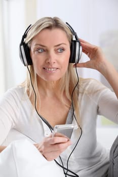 Portrait of beautiful blond woman with headphones on