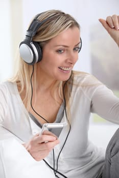 Portrait of beautiful blond woman with headphones on