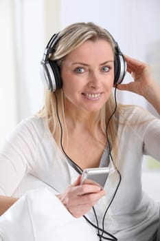 Portrait of beautiful blond woman with headphones on