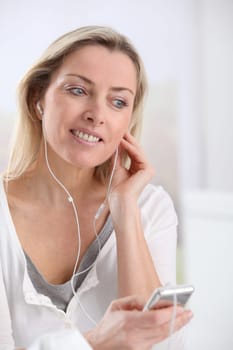 Beautiful blond woman listening to music