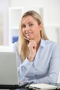 Beautiful blond woman working in the office