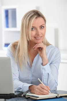 Beautiful blond woman working in the office