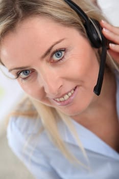 Closeup on blond woman with headset on