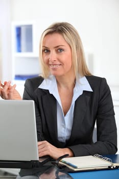 Businesswoman in the office with laptop computer