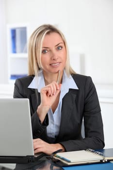 Businesswoman in the office with laptop computer