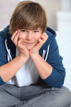 Portrait of young smiling boy with blue sweater