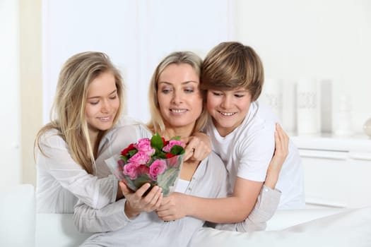 Children offering bunch of flowers on mother's day