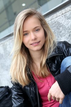 Closeup of teenage girl sitting on a school bench