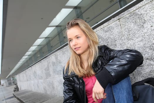 Closeup of teenage girl sitting on a school bench