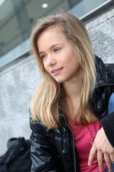 Closeup of teenage girl sitting on a school bench