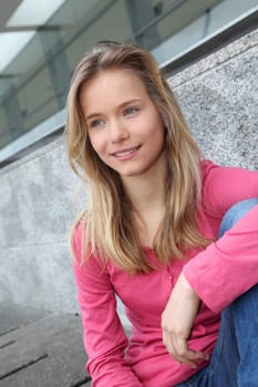 Closeup of teenage girl sitting on a school bench