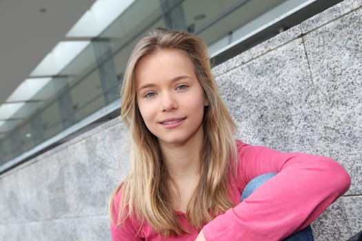 Closeup of teenage girl sitting on a school bench