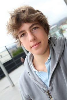 Portrait of teenage boy in front of school building