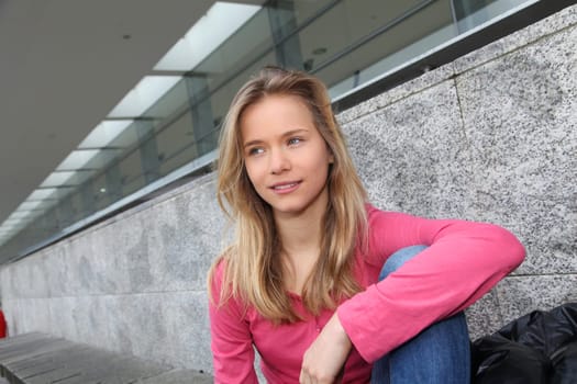 Closeup of teenage girl sitting on a school bench
