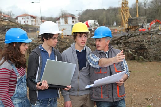 Adult with group of teenagers in professional training