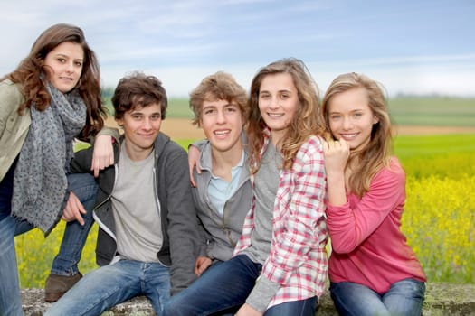 Group of teenagers sitting outside