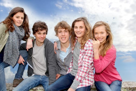 Group of teenagers sitting outside