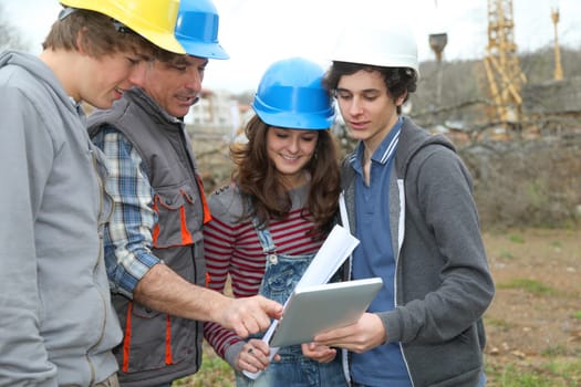 Adult with group of teenagers in professional training
