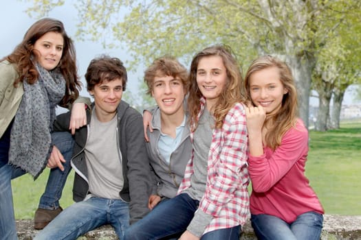 Group of teenagers sitting outside