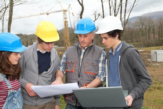 Adult with group of teenagers in professional training