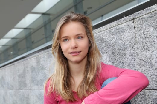 Closeup of teenage girl sitting on a school bench
