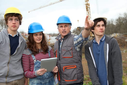 Adult with group of teenagers in professional training