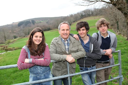 Adult man with teenagers in agricultural field