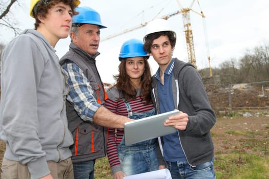 Adult with group of teenagers in professional training