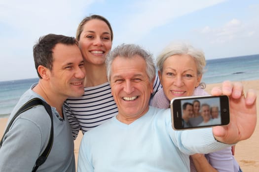 Family taking picture at the beach
