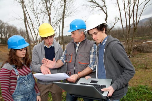 Adult with group of teenagers in professional training