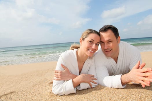Couple relaxing in bathrobe at the beach
