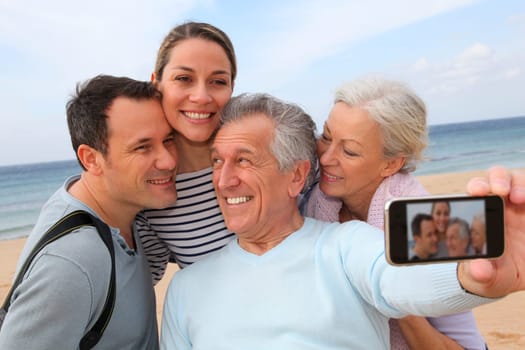 Family taking picture at the beach