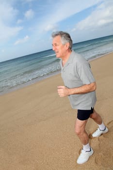 Senior man running on the beach