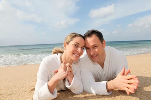 Couple relaxing in bathrobe at the beach