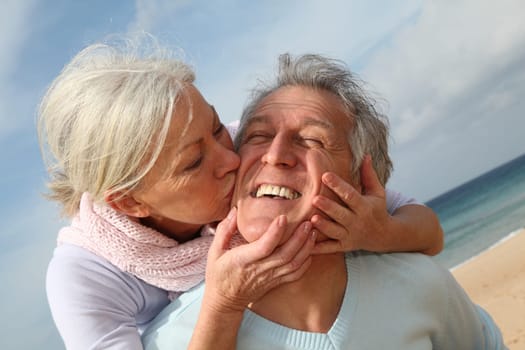 Happy senior couple at the beach