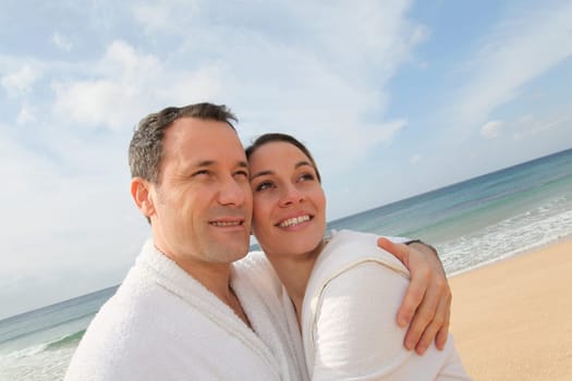 Couple relaxing in bathrobe at the beach