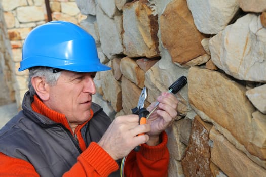 Worker with security helmet installing gate system