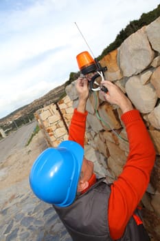 Worker with security helmet installing gate system