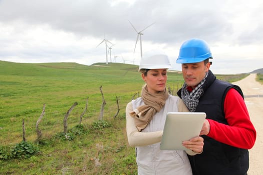 Engineers working with electronic tablet