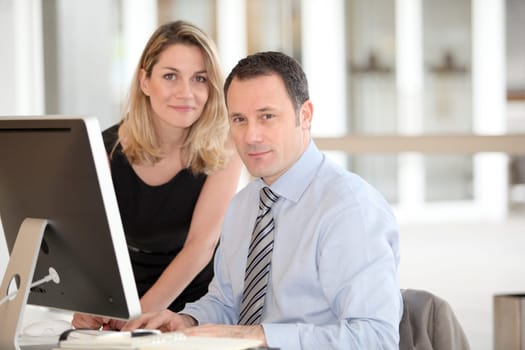 Office workers in front of computer
