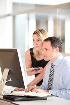 Office workers in front of computer