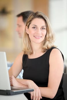 Businesswoman sitting in the office in front of laptop