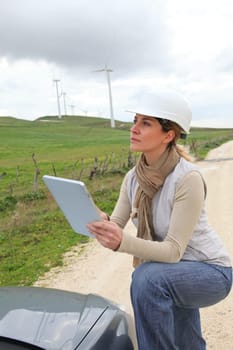 Engineer in wind turbines field using electronic tablet