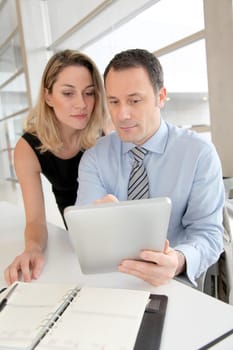 Business people working on electronic tablet