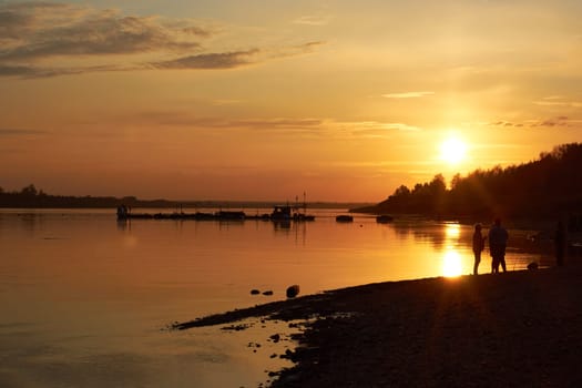 bright sunset on the river by the water