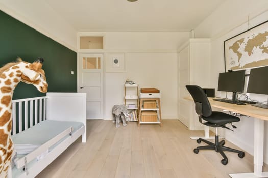 a gife standing in the corner of a room with a desk, chair and computer on it's side